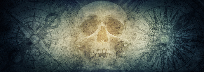 Cráneo de pirata y brújulas en el antiguo fondo de papel Grunge. photo