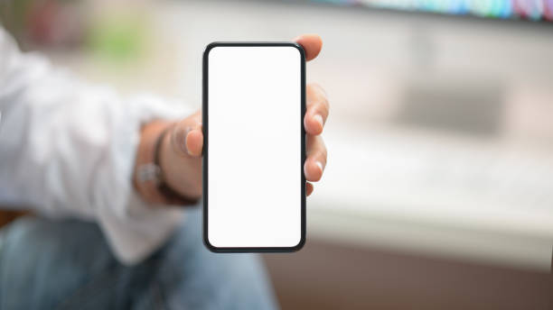 istock Business man showing blank screen mobile phone in office 1141230547