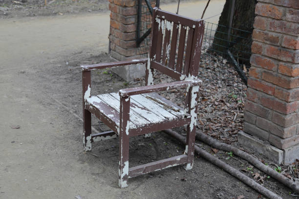 Old dirty wooden chair doused with white paint