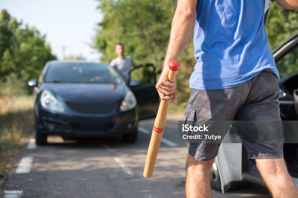 aggressive drivers attacked each other with  weapons in traffic Fighting Stock Photo