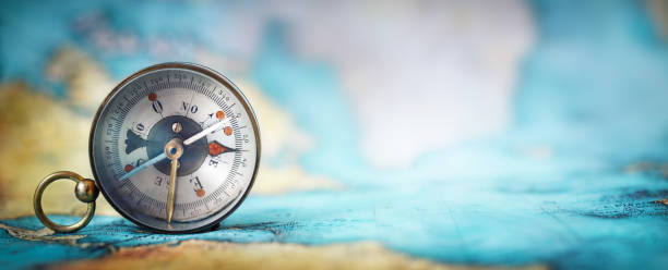Magnetic old compass on world map. Magnetic old compass on world map.Travel, geography, navigation, tourism and exploration concept wide background. Macro photo. Very shallow focus. navigational equipment photos stock pictures, royalty-free photos & images