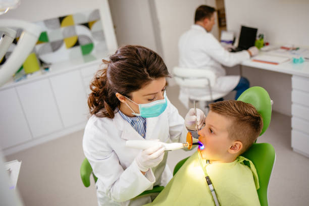 istock Boy receiving dental filling drying procedure 1141231200