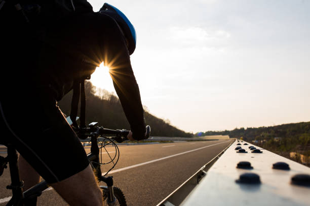 istock Cycling on the highway at sunset 1141231860