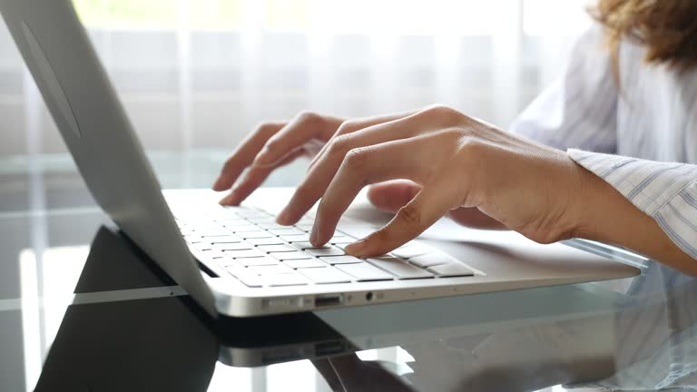 Close up of Woman hands using laptop computer, indoors