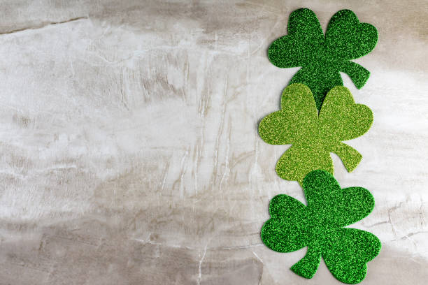 istock Three green shamrocks in a vertical line on right hand side 1141233874