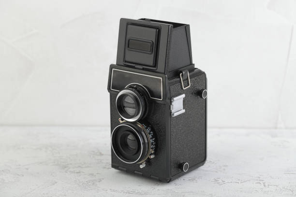 istock The old medium format film TLR camera, camera for modern lomography on white cement background. 1141236092