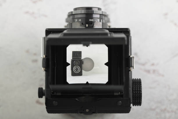 istock The old medium format film TLR camera, camera for modern lomography on white cement background. 1141236093