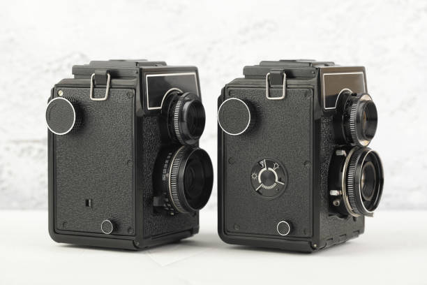 The old medium format film TLR cameras, cameras for modern lomography on white cement background.