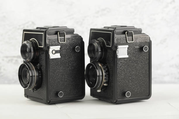 istock The old medium format film TLR cameras, cameras for modern lomography on white cement background. 1141236103