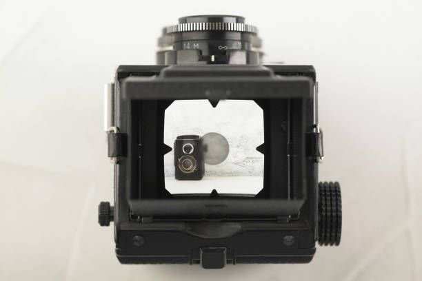 istock The old medium format film TLR camera, camera for modern lomography on white cement background. 1141236105