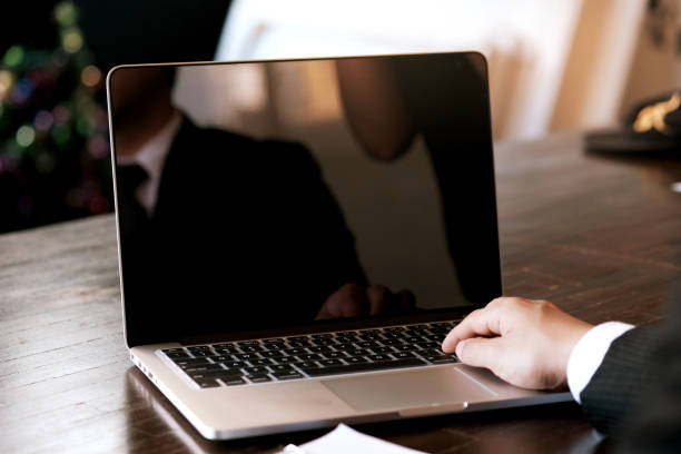 istock Man working by using a laptop computer on wooden table. Hands typing on a keyboard. 1141236568