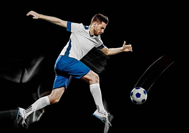 istock caucasian soccer player man isolated black background light painting 1141237726