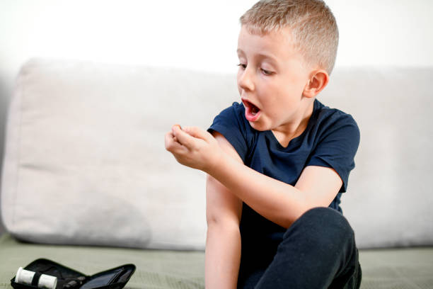 istock Diabetic child injecting insulin 1141238042