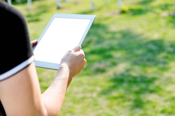 Woman hand using a digital tablet outdoors.