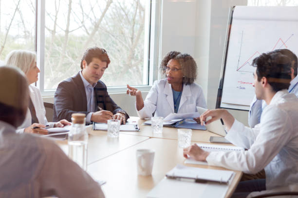 Mature doctor discusses something during conference