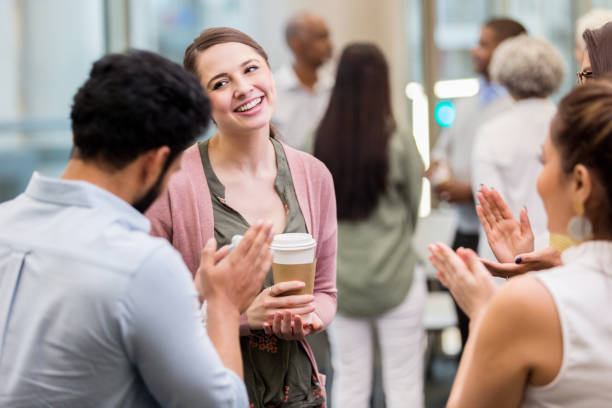 Businesspeople applaud colleague
