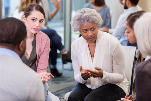 istock Mature woman gives advice during support group meeting 1141239201