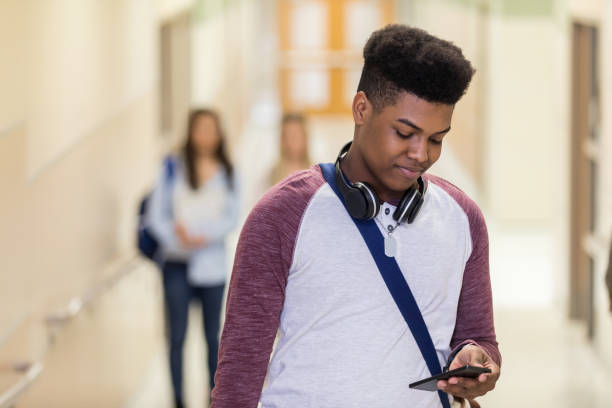 istock After class, a young teen check his smart phone 1141239363
