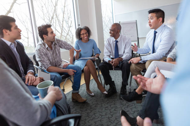 istock Young Asian businessman talks with employees 1141239452