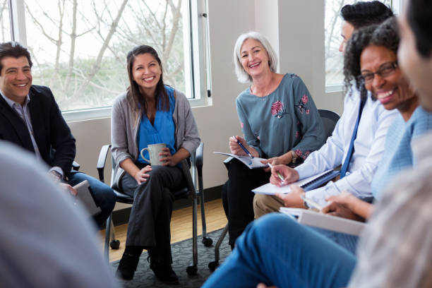 istock Smiling business people look at unrecognizable employee 1141239473