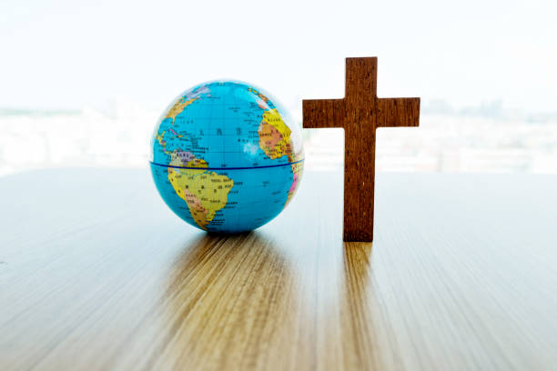 istock Earth globe and cross in table 1141239527