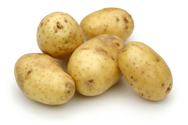 istock Heap of fresh potatoes isolated on white 1141239972