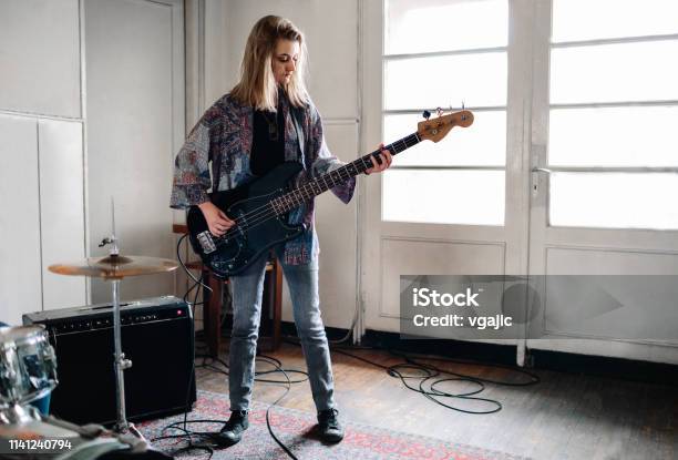 Female Bass Guitarist On Rehearsal Stock Photo - Download Image Now - Bass Guitar, Playing, Teenage Girls
