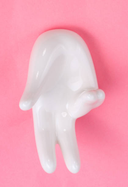 istock Ceramic stand with hand shape on pink background 1141241678