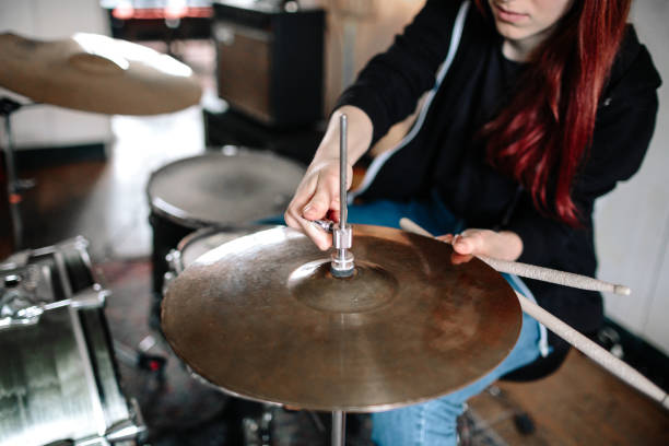 istock Female Drummer Adjusting Cymbal 1141241685