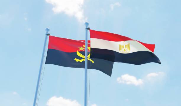istock Egypt and Angola, two flags waving against blue sky 1141243037