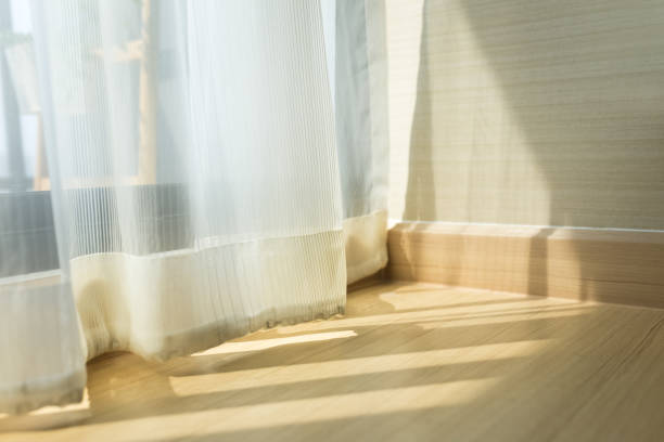 istock morning sunlight through curtain in room 1141243436