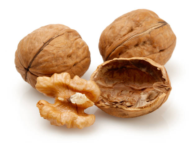 istock Whole and cracked walnuts isolated on white 1141244021