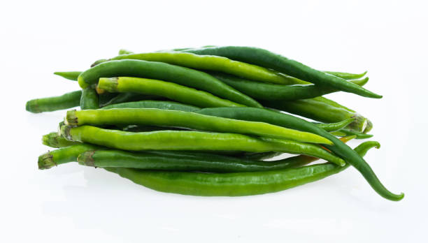 Green chili peppers on white background Green chili peppers on white background. relish green food isolated stock pictures, royalty-free photos & images