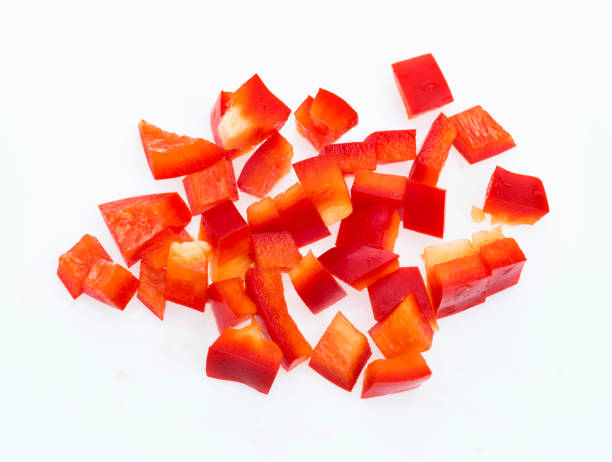 istock Red bell pepper dices on white background 1141246544