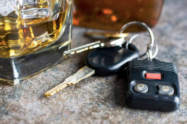 istock Brandy glass with keys and nearly empty bottle in background. 1141246851