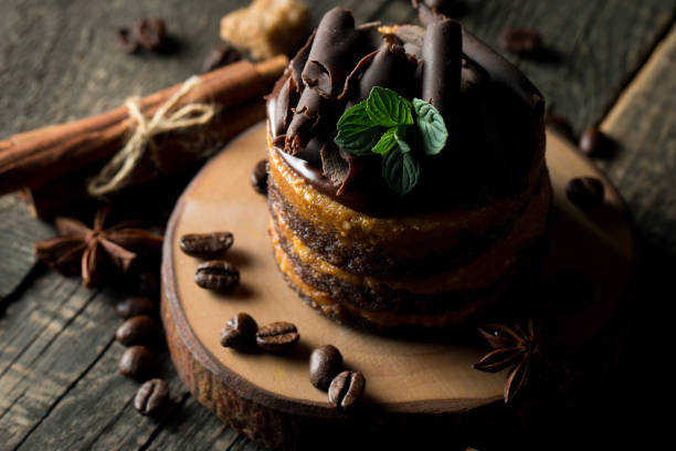 istock Chocolate cakes on black slatter board with mint, coffee beans on dark background, closeup photo. Fresh, tasty dessert food concept. 1141248478