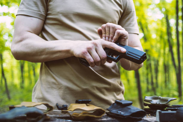 istock guy in the woods tests his weapons for shooting sports 1141250149