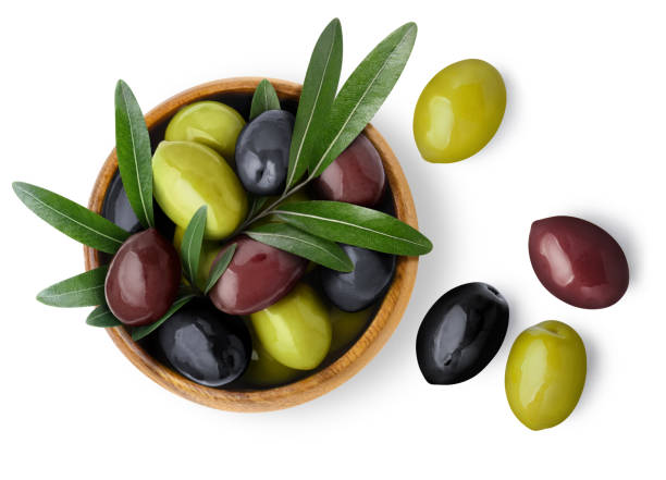Olives on white Delicious black, green and red olives with leaves in a wooden bowl, isolated on white background, view from above giant fictional character photos stock pictures, royalty-free photos & images
