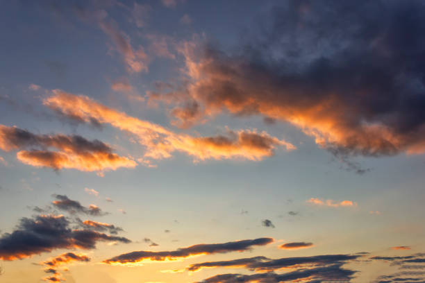 istock Blue sky with gold clouds - dramatic sunset, beautiful natural background. Setting sun illuminates the clouds. 1141250671