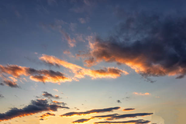 istock Blue sky with gold clouds - dramatic sunset, beautiful natural background. Setting sun illuminates the clouds. 1141250677