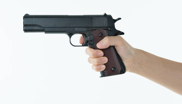 istock Woman hand holding a gun 1141250738