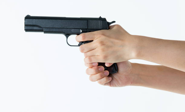 istock Woman hands holding a gun 1141250767