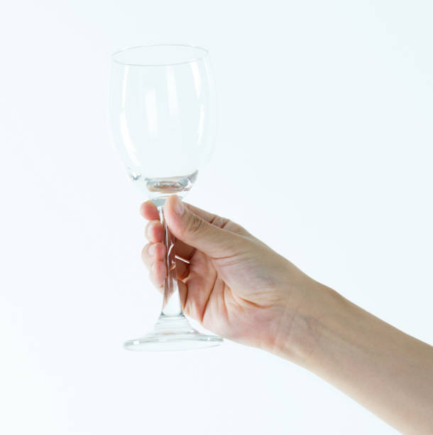 istock Woman hand holding empty wine glass 1141251546