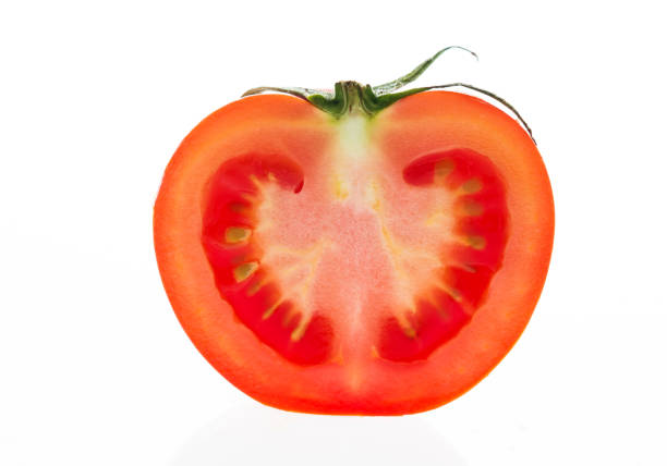 istock Half of tomatoe on white background 1141251844