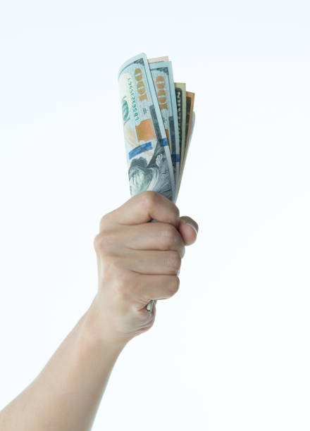 Woman hand holding US dollar bills.
