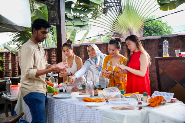 istock Friends preparing food for celebration 1141254441