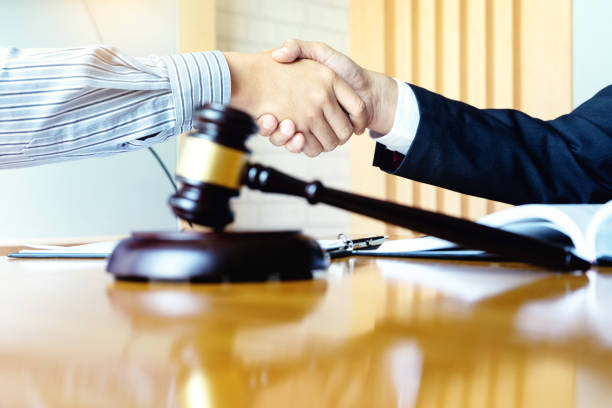 istock Lawyer or judge gavel with balance handshake with client 1141255350