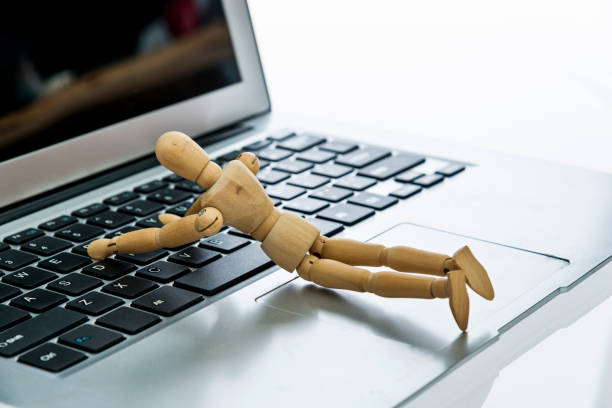 istock Wooden figurine typing on keyboard 1141255801