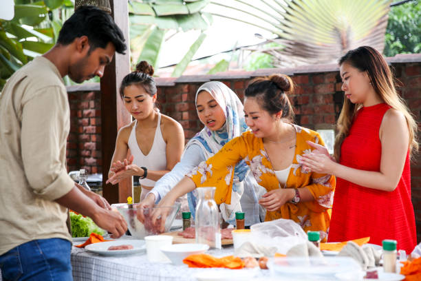 istock Friends preparing food for celebration 1141255972
