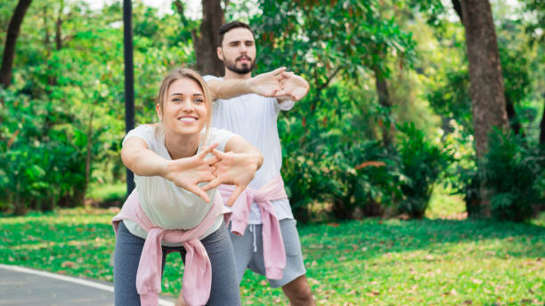 istock A Young couple warm up and excercise in the park 1141257843